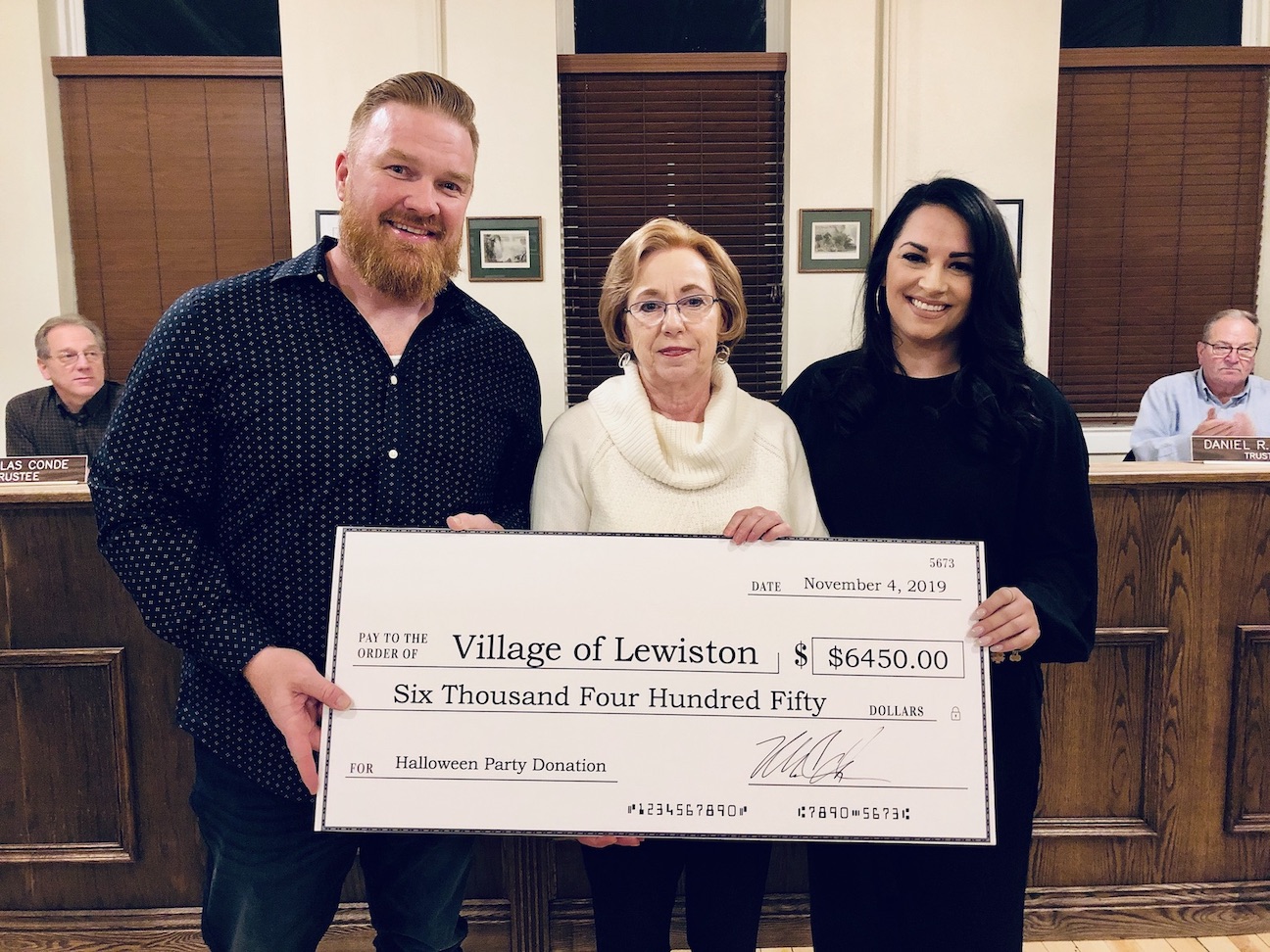 Michael Carroll and his girlfriend, Brittney Page, present a donation to Village of Lewiston Mayor Anne Welch prior to Monday's Village Board work session.
